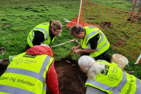 Volunteers digging in the test pit