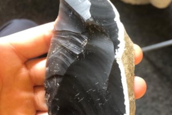 hand holding a flint tool
