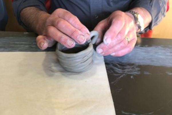 participant making a clay cup