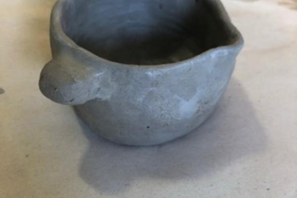 a small handmade clay cup