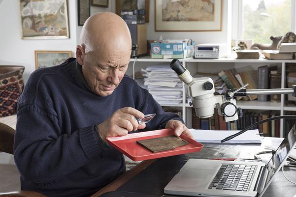 Roger Tomlin closely examines one of the Bloomberg tablets