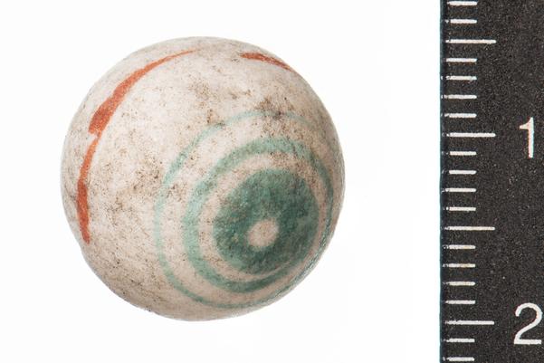 white alley with pale blue bullseye and red line around the centre