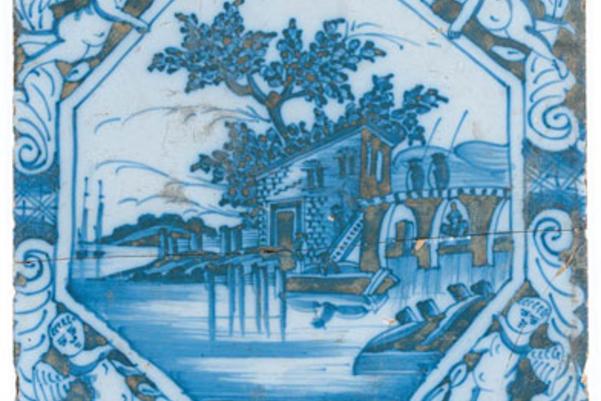 Photo of a blue and white tile with an intricate  landscape design