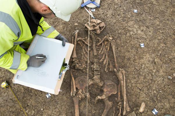 An archaeologists recording the burial